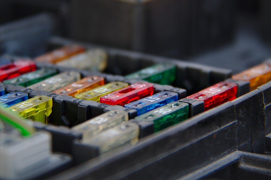 Multiple rows of fuses in the fusebox of a car